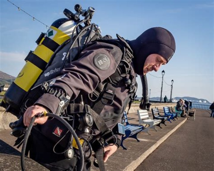 How do divers stay warm in cold water?