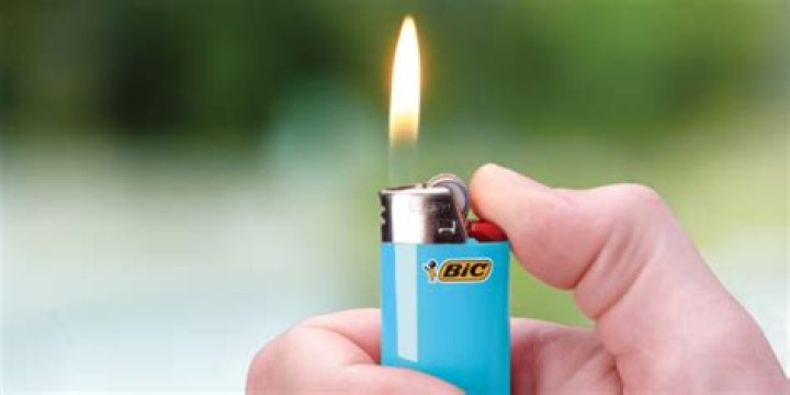 How do you adjust the flame on a Bic lighter?